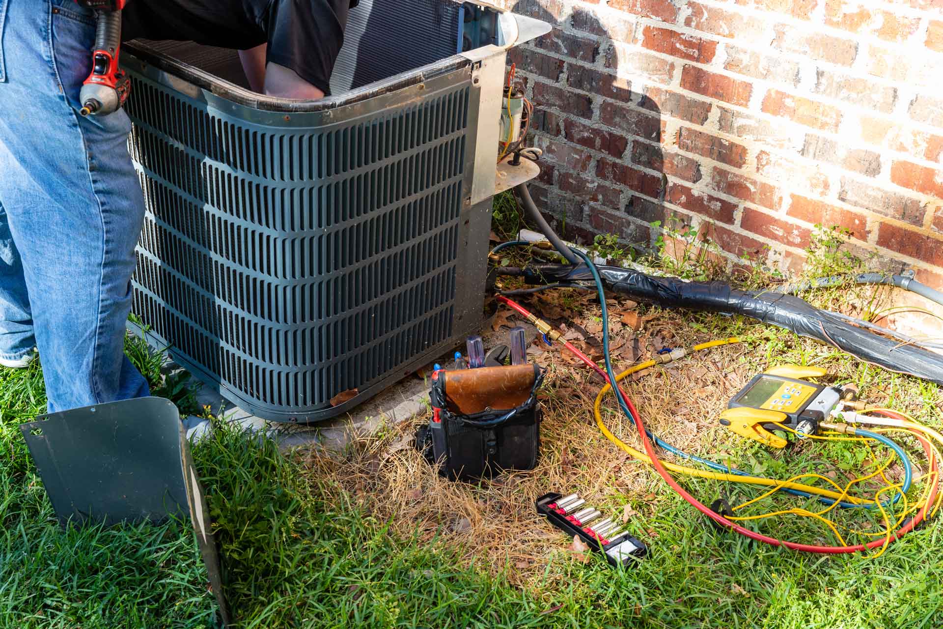 Close-up shot of technician repairing the fan in a large AC unit